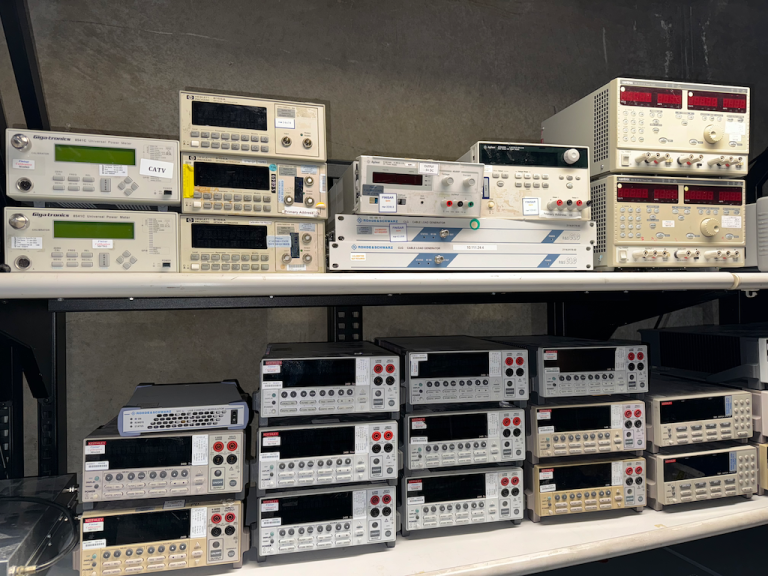 Two shelves full of various used lab equipment for sale in San Diego